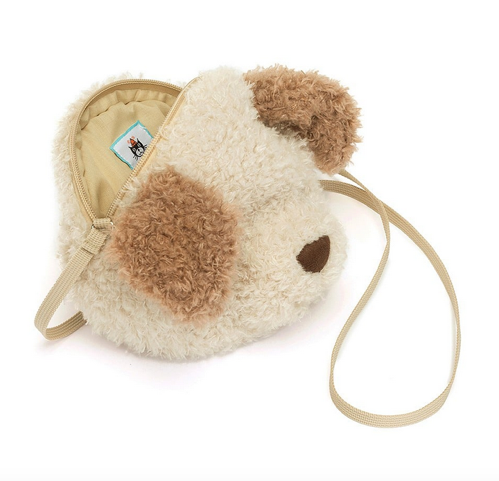 The Little Pup plush bag opened at the top zipper to show the inside. 