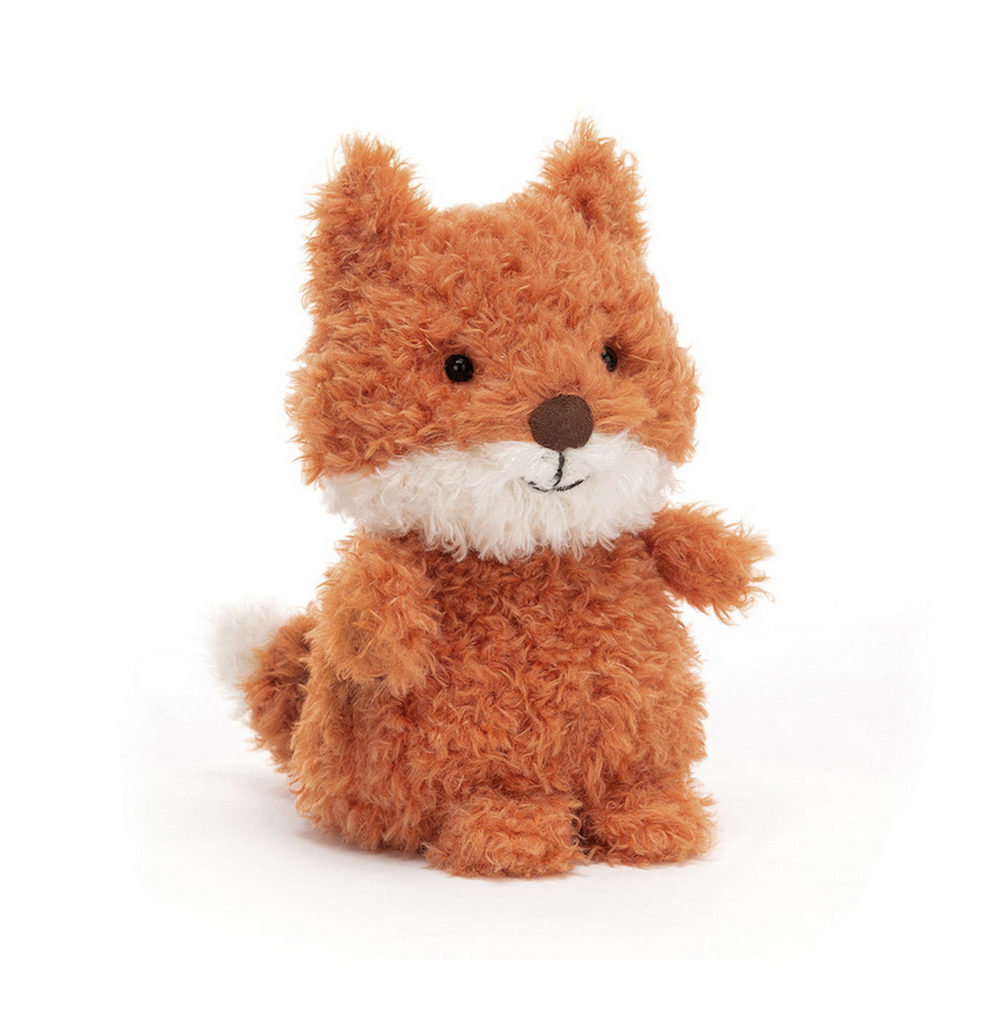 Small, fuzzy plush fox stuffed animal with orange body and head with white muzzle and tip of tail. 