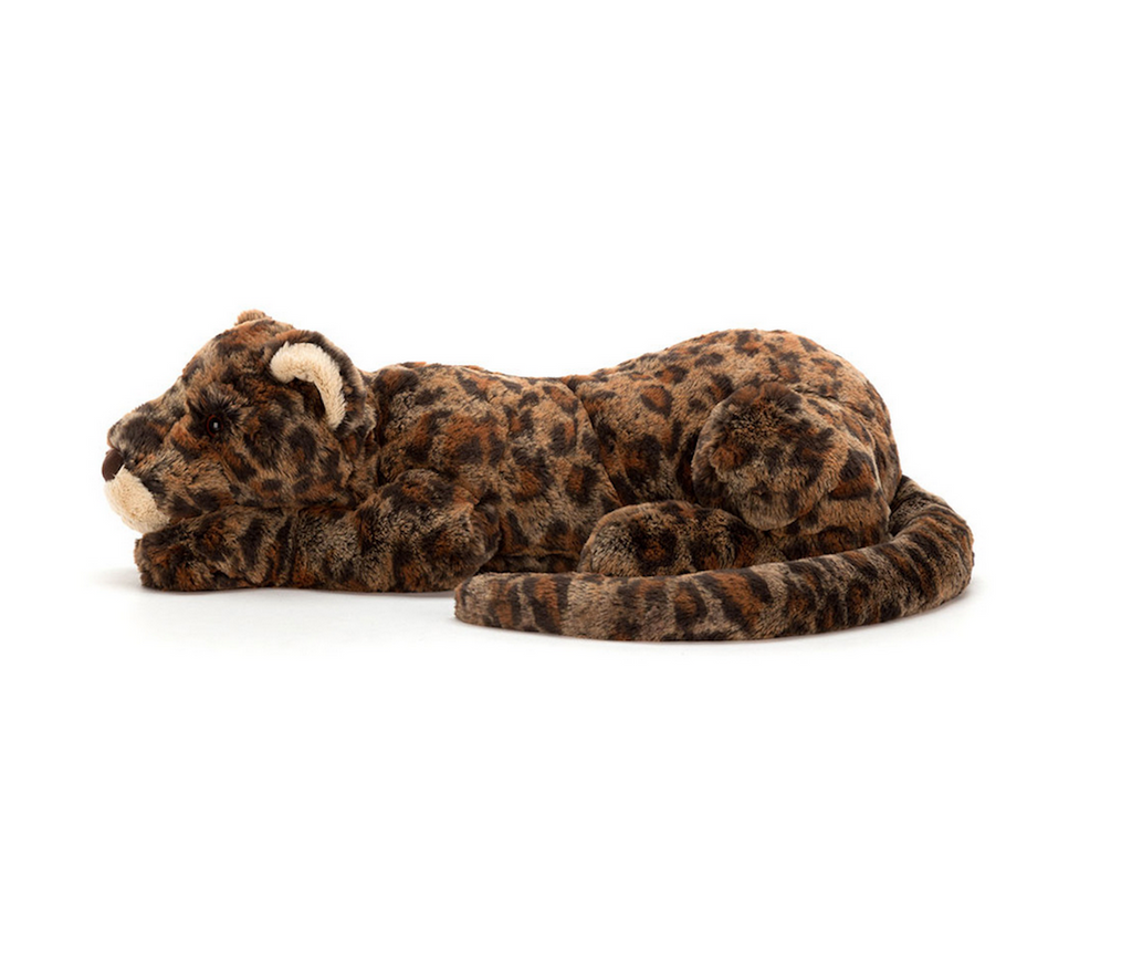 Plush leopard lying down and viewed from the side with it's tail wrapped around itself. 