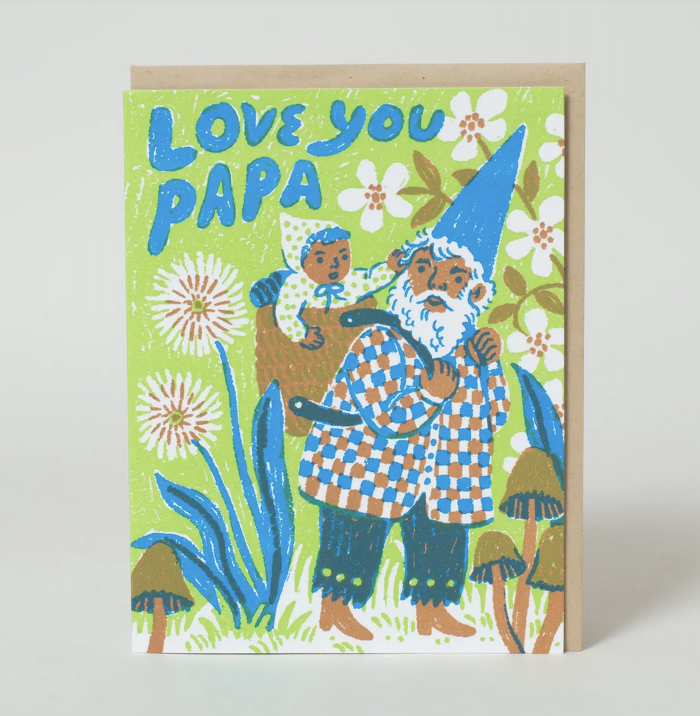 A sweetly illustrated greeting card featuring a papa gnome carrying a baby on his back amongst a flowery field that reads "Love You Papa" 