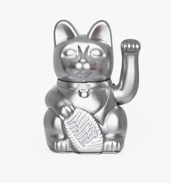 Shiny silver lucky cat statue that waves it's arm when batteries are installed. It's holding a banner that translates to "Good luck"