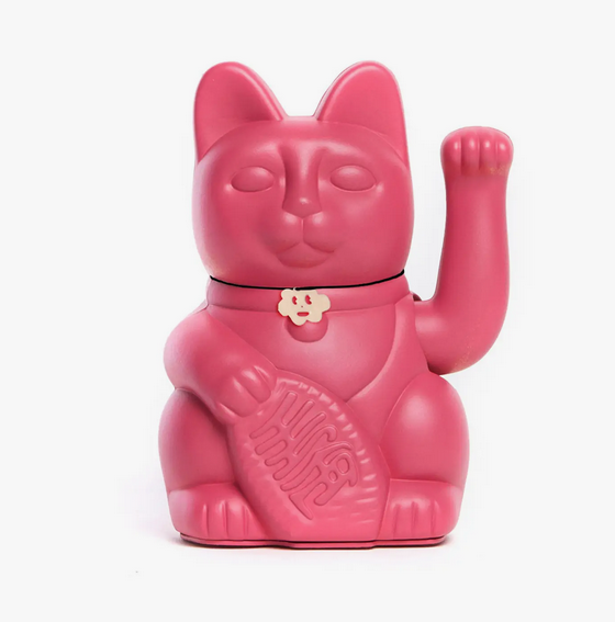 Violet red Lucky Cat statue with waving arm and holding a banner that translates to "Good Luck"