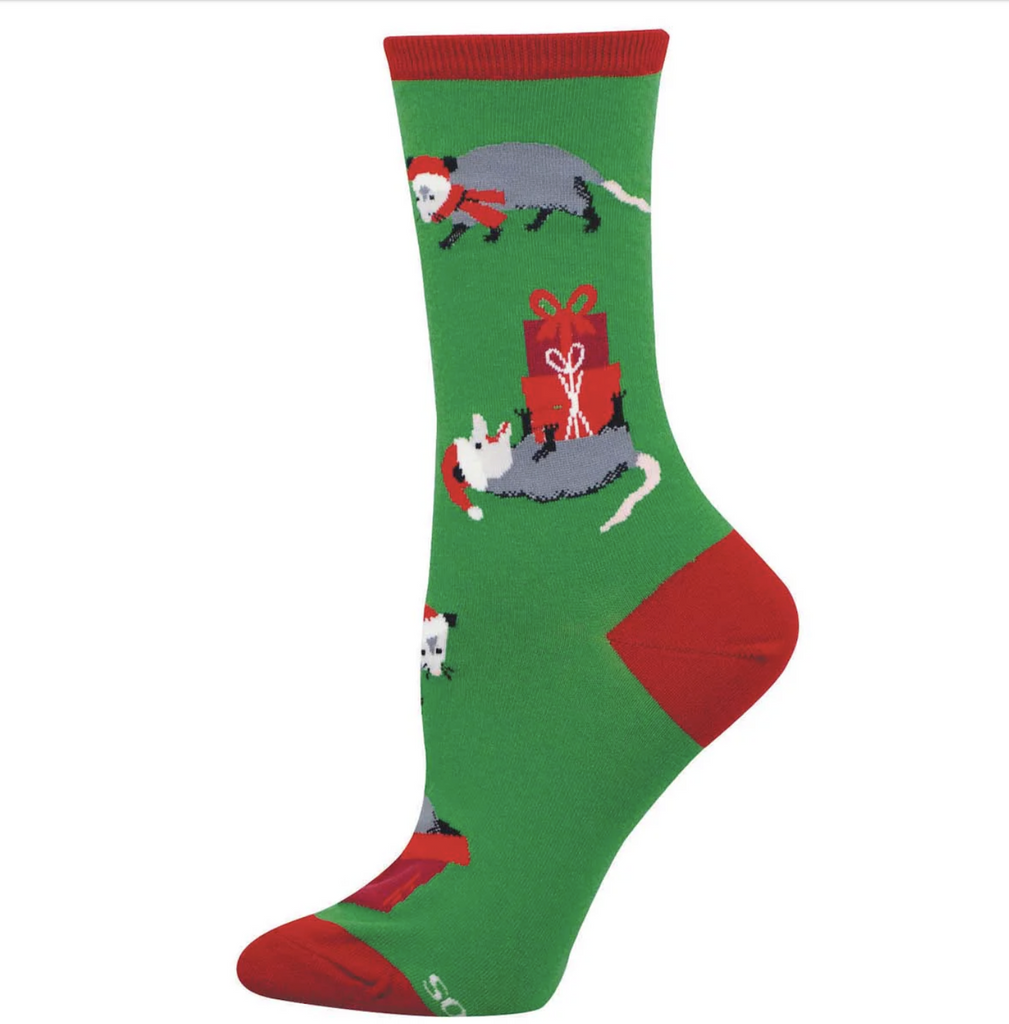 Green and red Christmas socks with possums in Santa hats and scarves rolling around with wrapped presents. 
