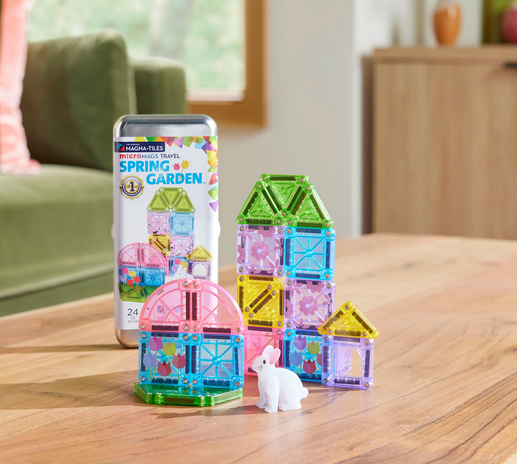 Set of colorful magnetic building tiles with packaging on a wooden table
