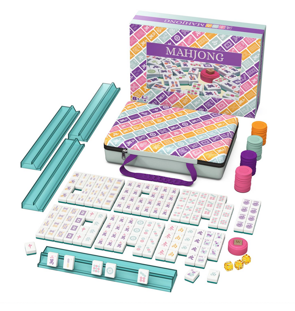 Mahjong tiles, teal tile racks, dice, wind indicator, and scoring chips laid out along with the carrying case and game box. 