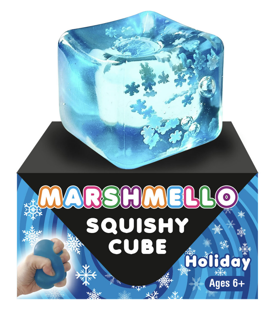 The Marshmellow Squishy Cube with snowflakes inside sitting atop a block with colorful lettering and a picture of a hand squeezing the squishy cube. 