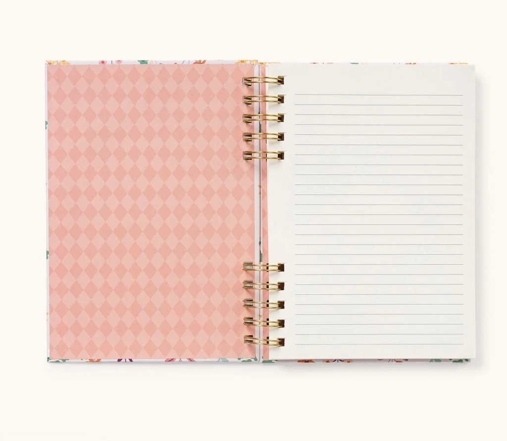Open planner with pink diamond pattern on the inside of the cover and lined pages. 