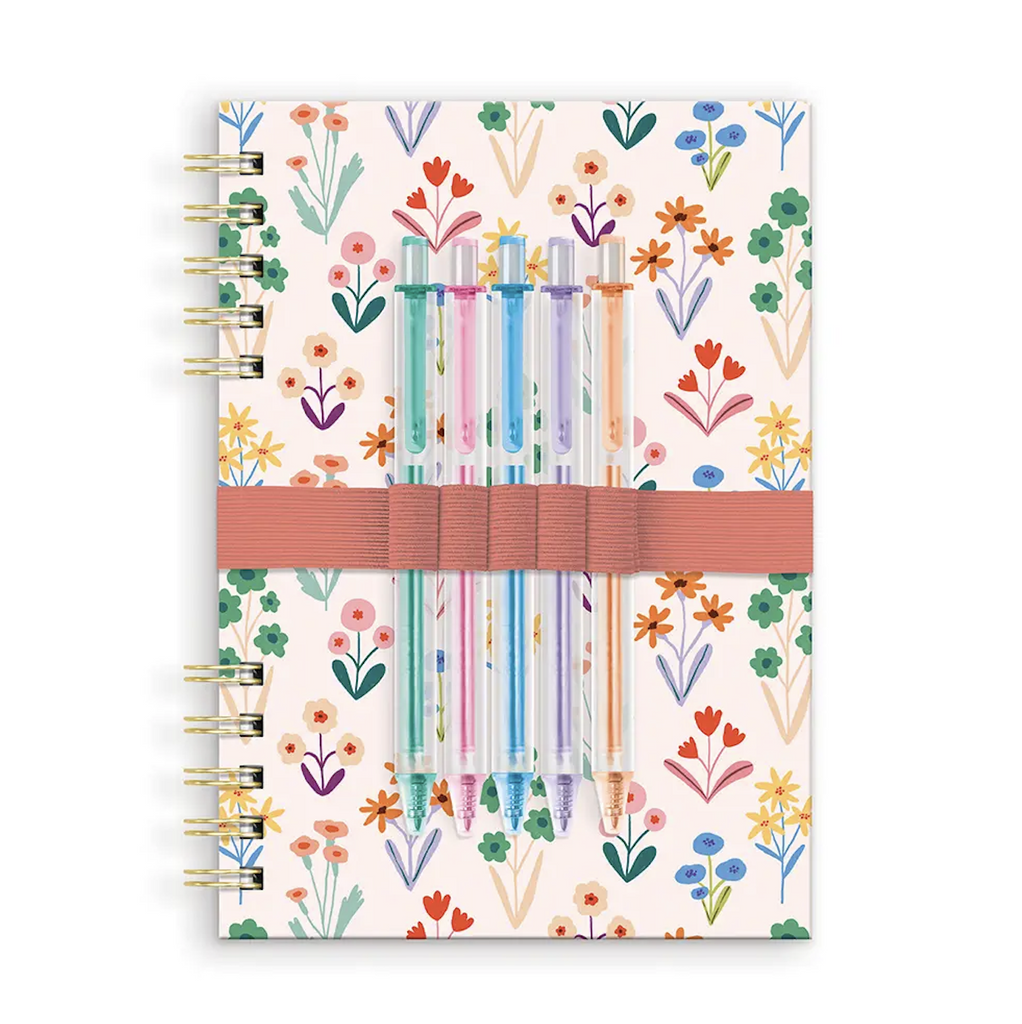Spiral bound notebook with floral patterned cover and elastic band holding 5 colored gel pens. 