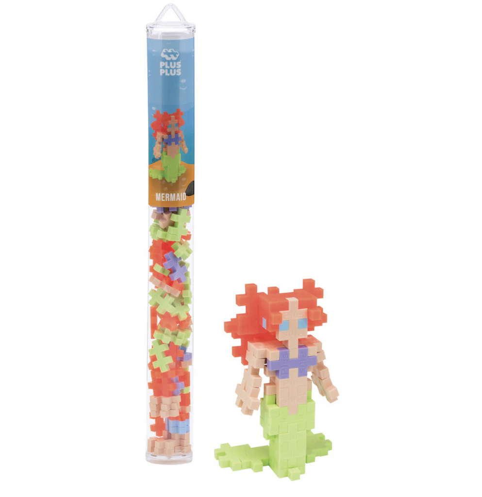 Plus Plus Mermaid 70 Piece tube with a mermaid constructed with pieces from the set. 