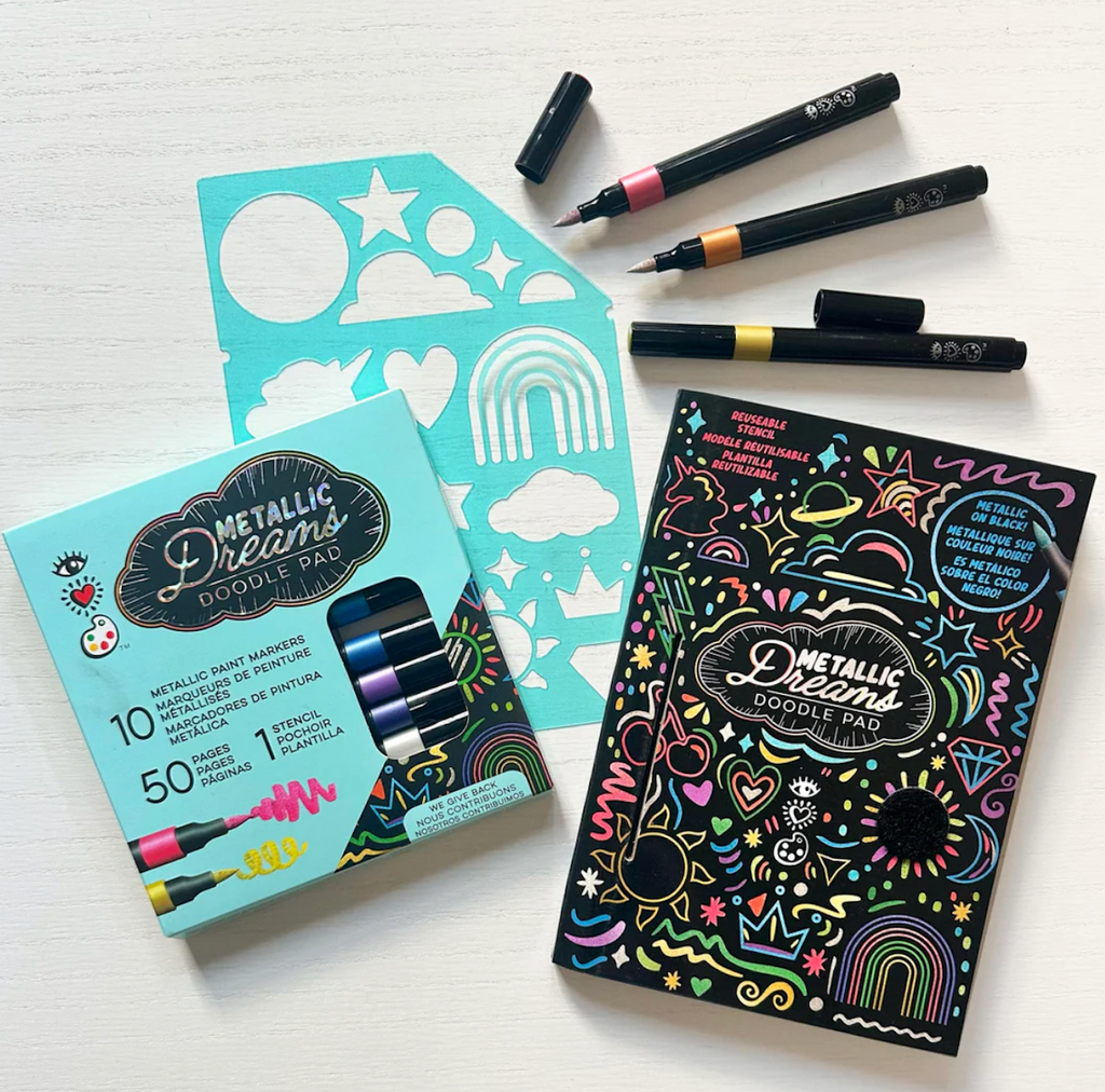 Metallic Dreams doodle pad, markers, and the stencil laid out on a white background. 