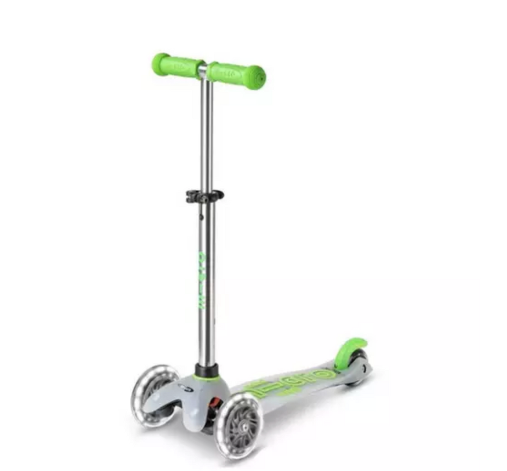 The Micro Mini Flux LED Scooter with bright green handlebars a translucent deck and light up LED wheels. 