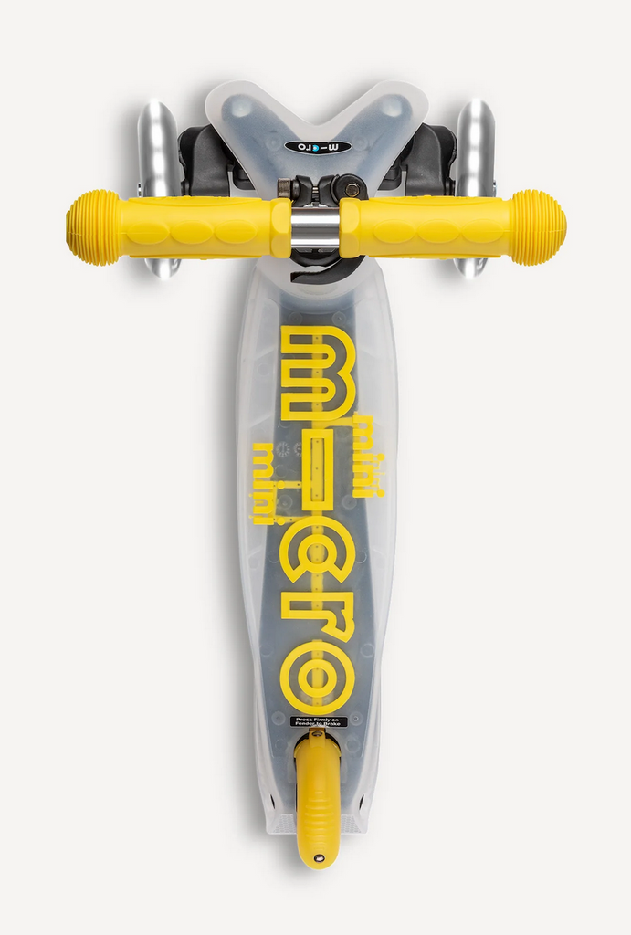 Micro Mini Flux LED Scooter in yellow which has yellow handlebars and translucent deck viewed from above. 