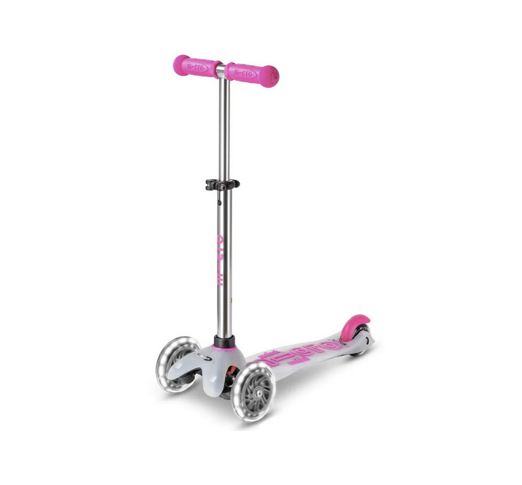 Micro Mini Flux LED Scooter in Neon Pink with a translucent kickboard that has neon pink handlebars and lettering, along with LED wheels. 
