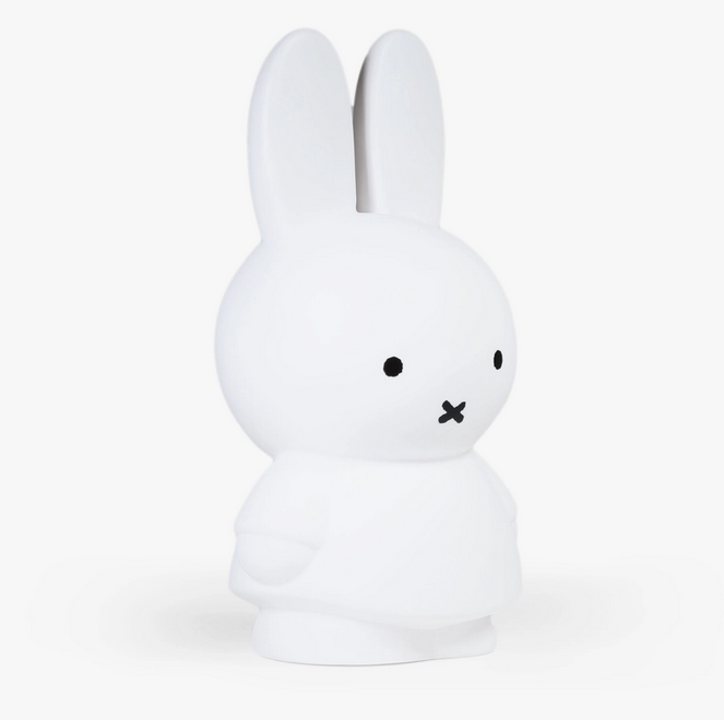 Side view of the standing white Miffy figure coin bank. 