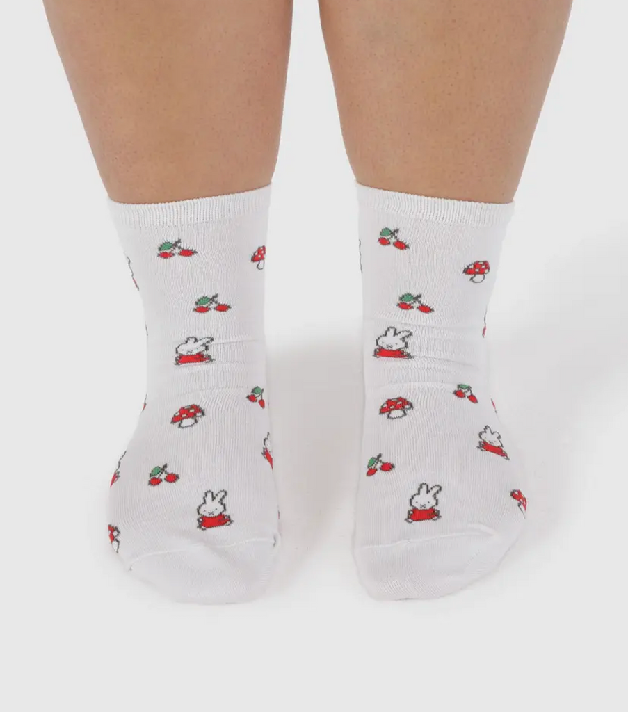 A pair of feet wearing the white Miffy crew socks. 