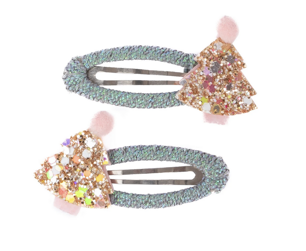Set of holiday themed hair clips with a mint-colored braided base, topped with a sparkling pink and gold Christmas tree at one end of each clip. 
