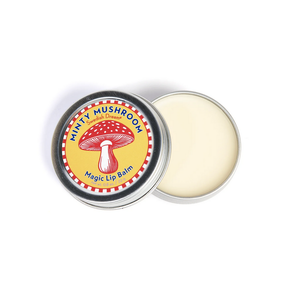 Minty Mushroom Magic Lip Balm tin opened with the red and yellow label featuring a mushroom. 