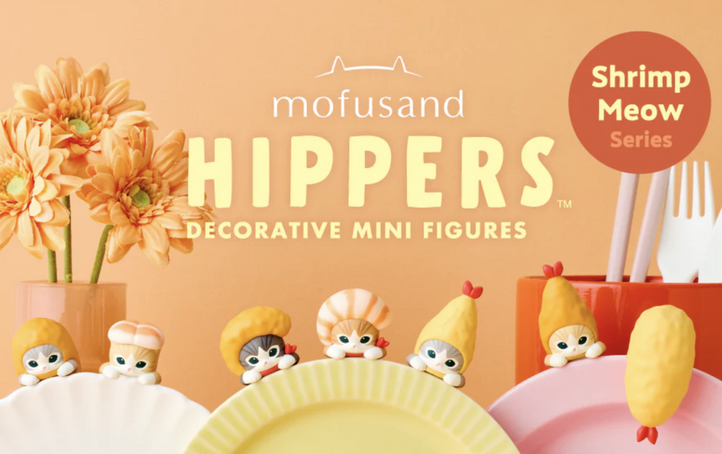 Small vinyl figures of various cats wearing hats made out of fake shrimp on plates.