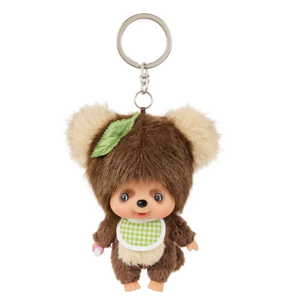 Mini Monchhichi plush keychain  with Monchhihchi dressed as the raccoon dog Tanuki, wearing a green gingham bib. 