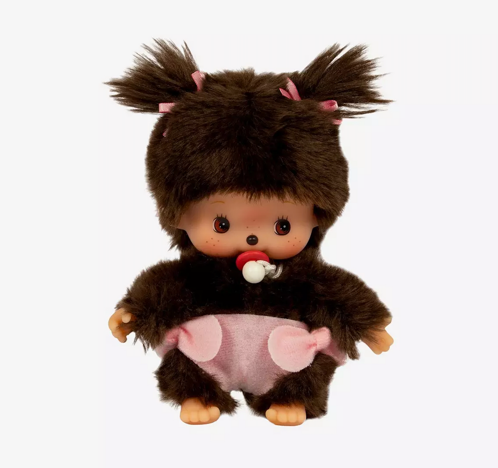Close up picture of the Bebichhichi Monchhichi girl wearing a pink diaper with her pacifier in her mouth. 