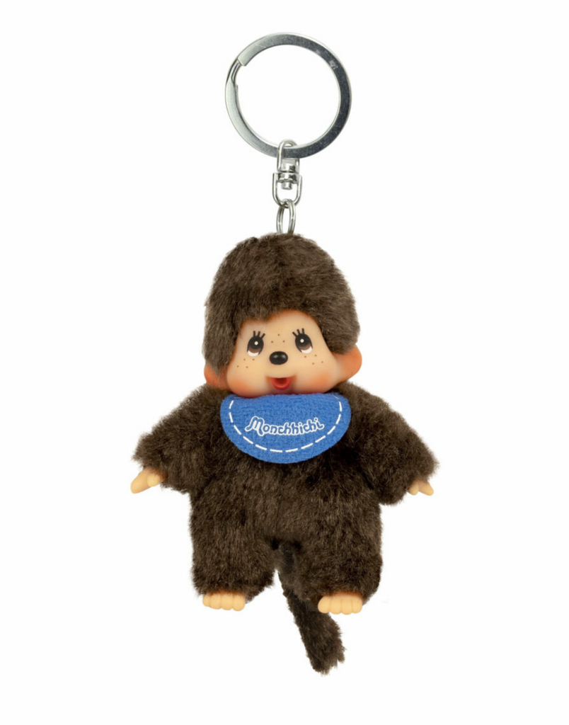 Monchhichi mini plush doll wearing a blue bib attached to round, silver key ring. 