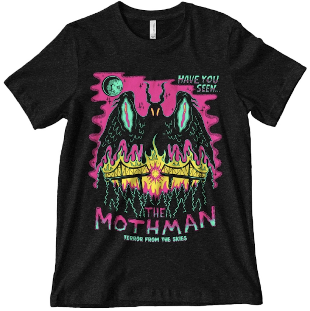 Bright illustration of The Mothman in pinks and green printed on a black t-shirt. 
