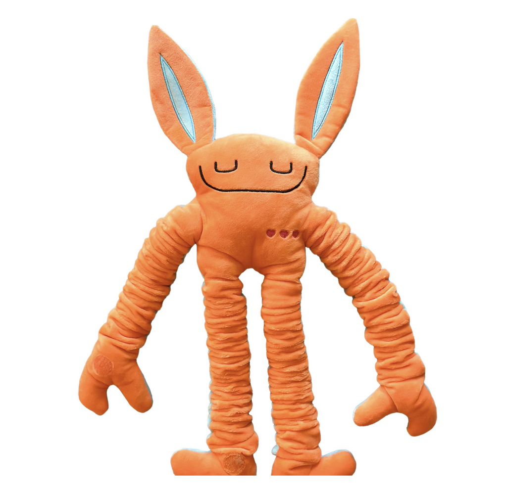 The front of a Mushies Pop plush doll in orange with blue lined ears. 