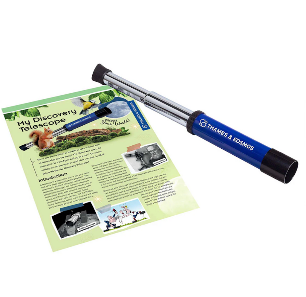 Handheld telescope with the information booklet that comes with the My Discovery Telescope from Thames and Kosmos. 