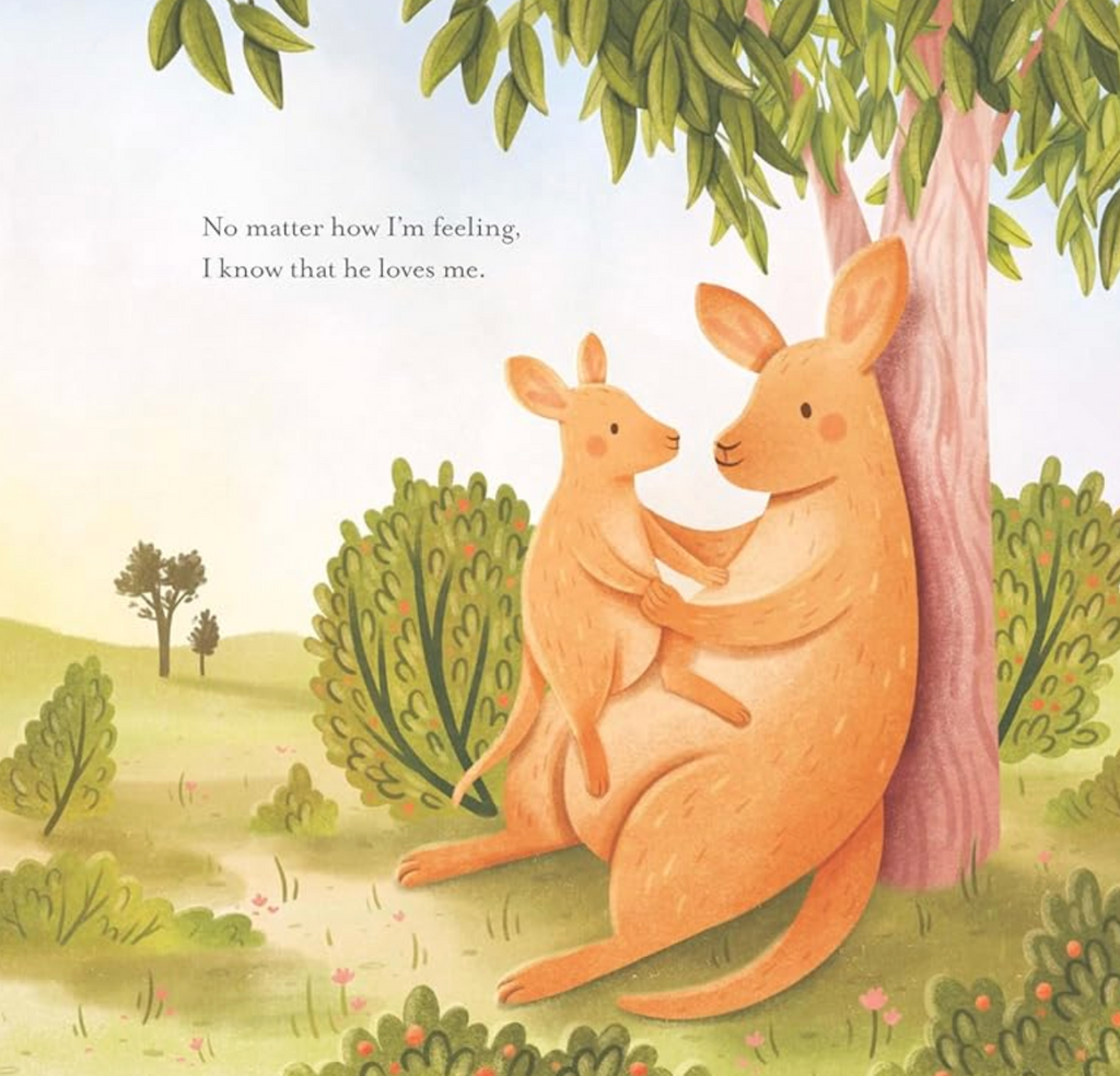 Interior page from the book "My Father's Arms" showing a father and baby kangaroo sitting under a tree with text that reads "No matter how I'm feeling, I know that he loves me."