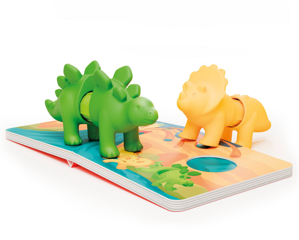 Magnetic dinosaur toys placed on the open story book from SmartMax My First Story Books Dino Friends. 