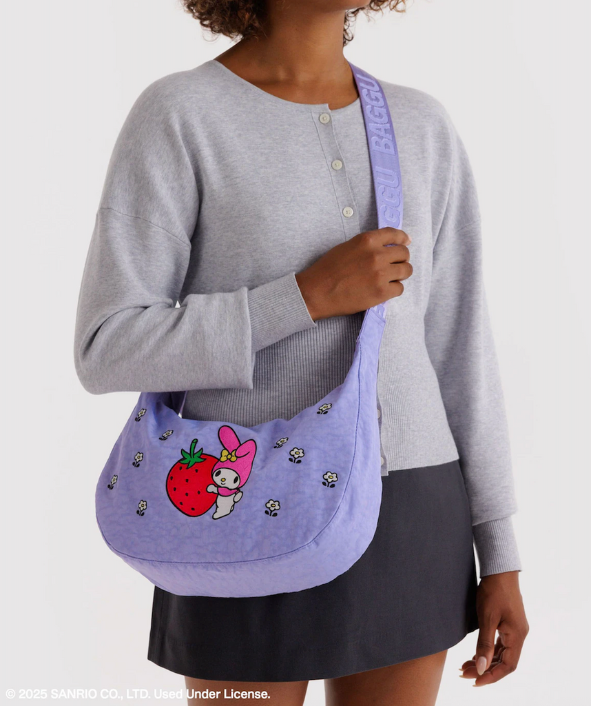 A person wearing the My Melody Strawberry Crescent Bag by Baggu. 