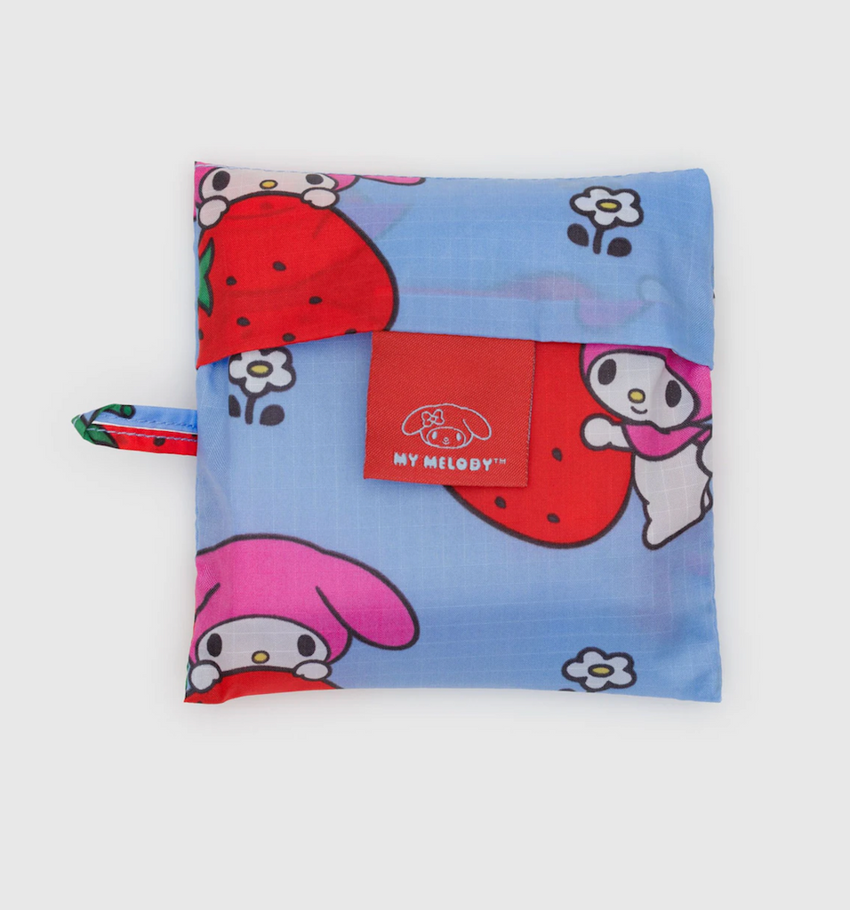 My Melody Sanrio character with a strawberry patterned standard Baggu bag in it's storage pouch. 