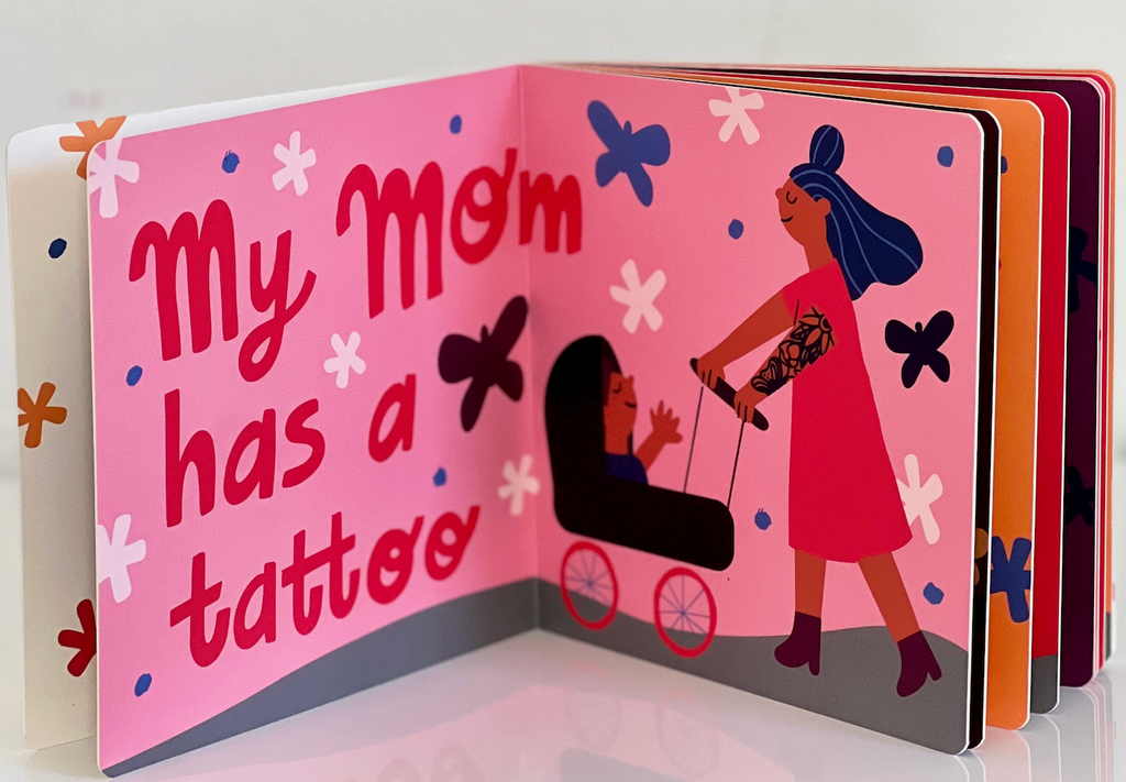 Interior pages from "My Mom Has a Tattoo " with an illustration of a tattooed mom pushing a baby in a stroller. 