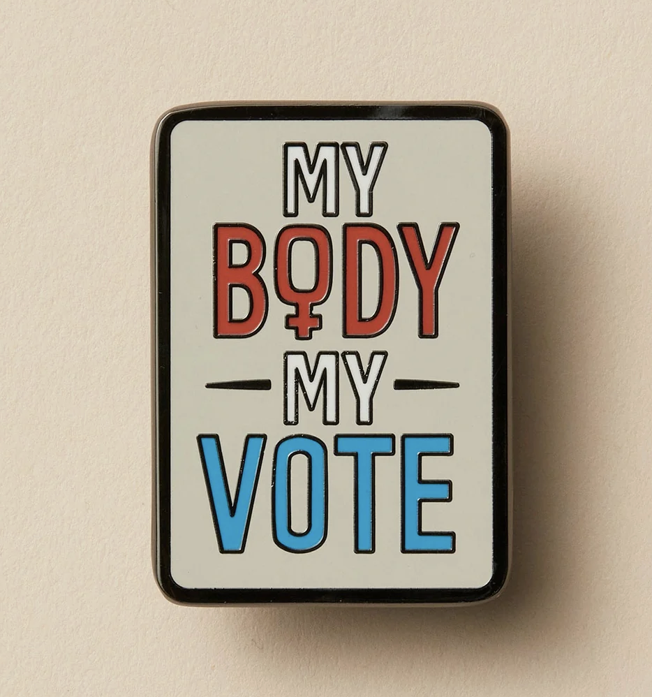 Enamel pin eith red, white and blue lettering  that reads "My Body My Vote"