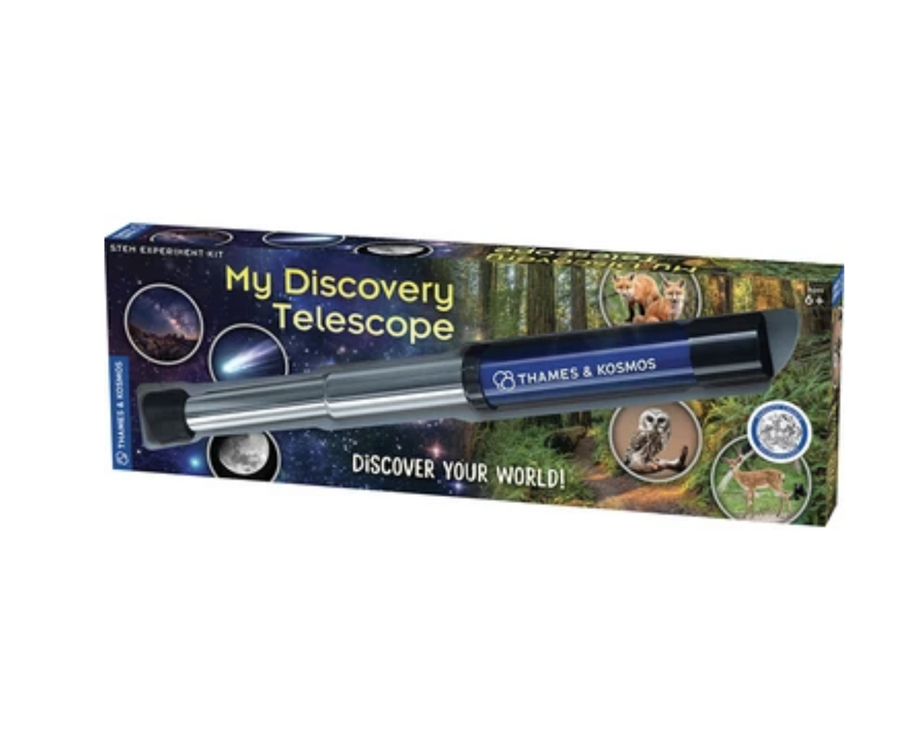The My Discovery Telescope from Thames packaged in a box with a clear plastic window that allows the blue and silver telescope to be seen while the box has pictures of a forest and wildlife, as well as the night sky. 