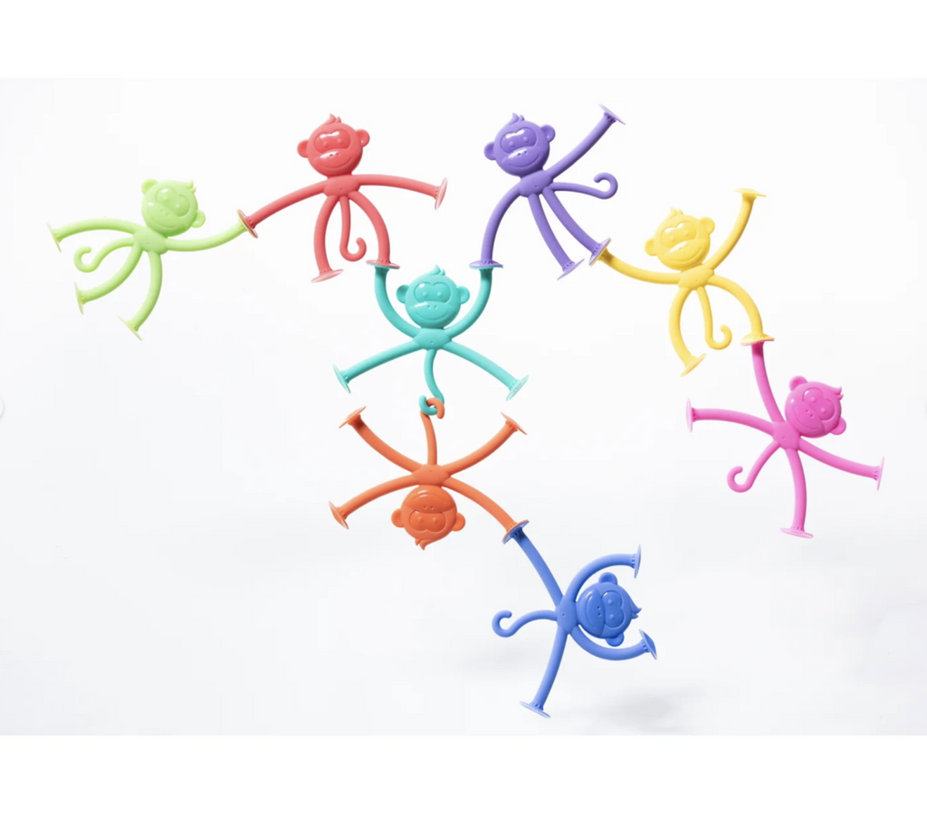 8 brightly colored monkey shaped silicone Hangatangs on a white background.