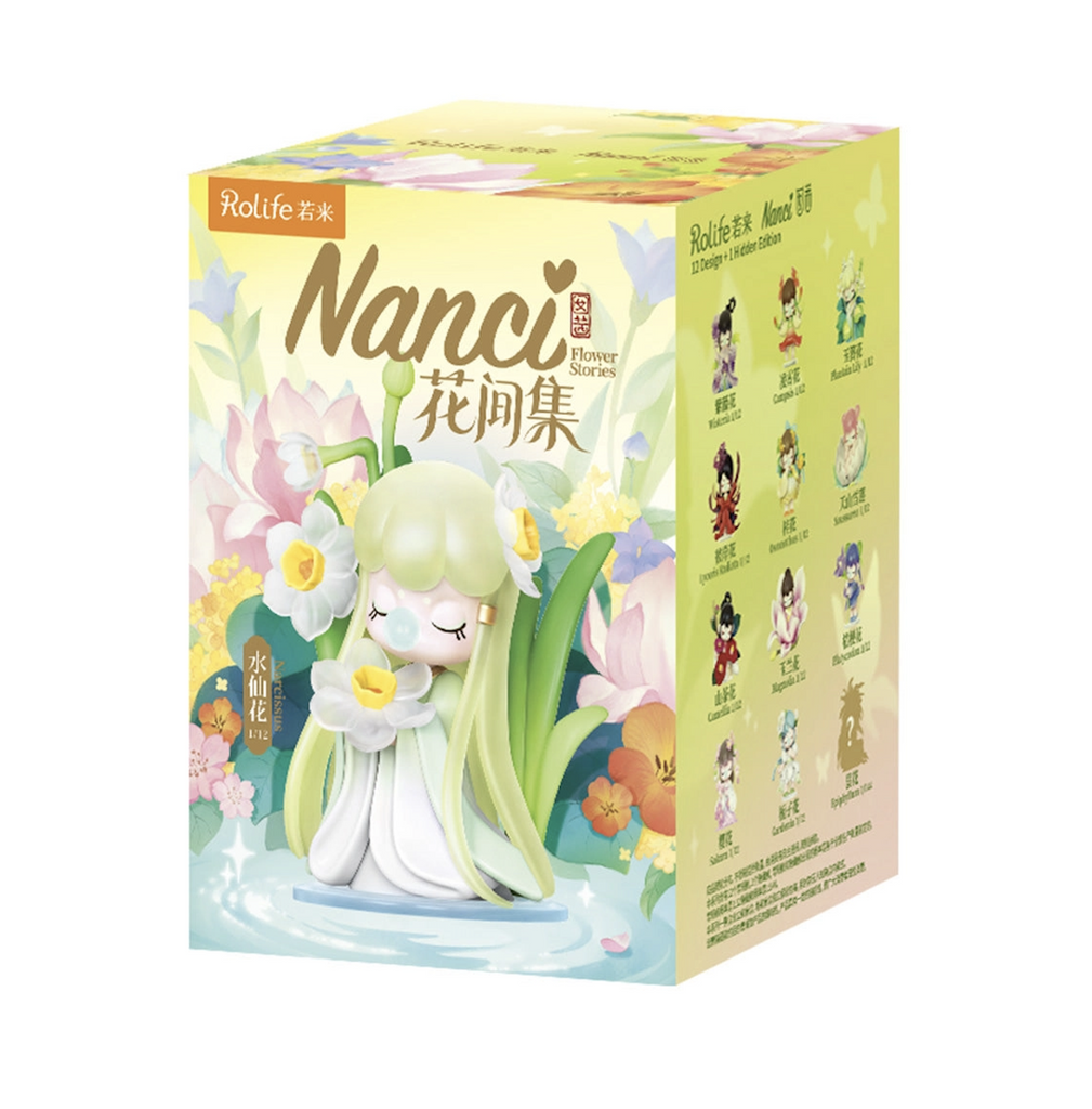 Yellow box with a picture of a Nanci collectible figure with long blond hair holding a daffodil while kneeling, she is surrounded by flowers. One side of the box is slightly visible that shows depictions of the figures in the series. 