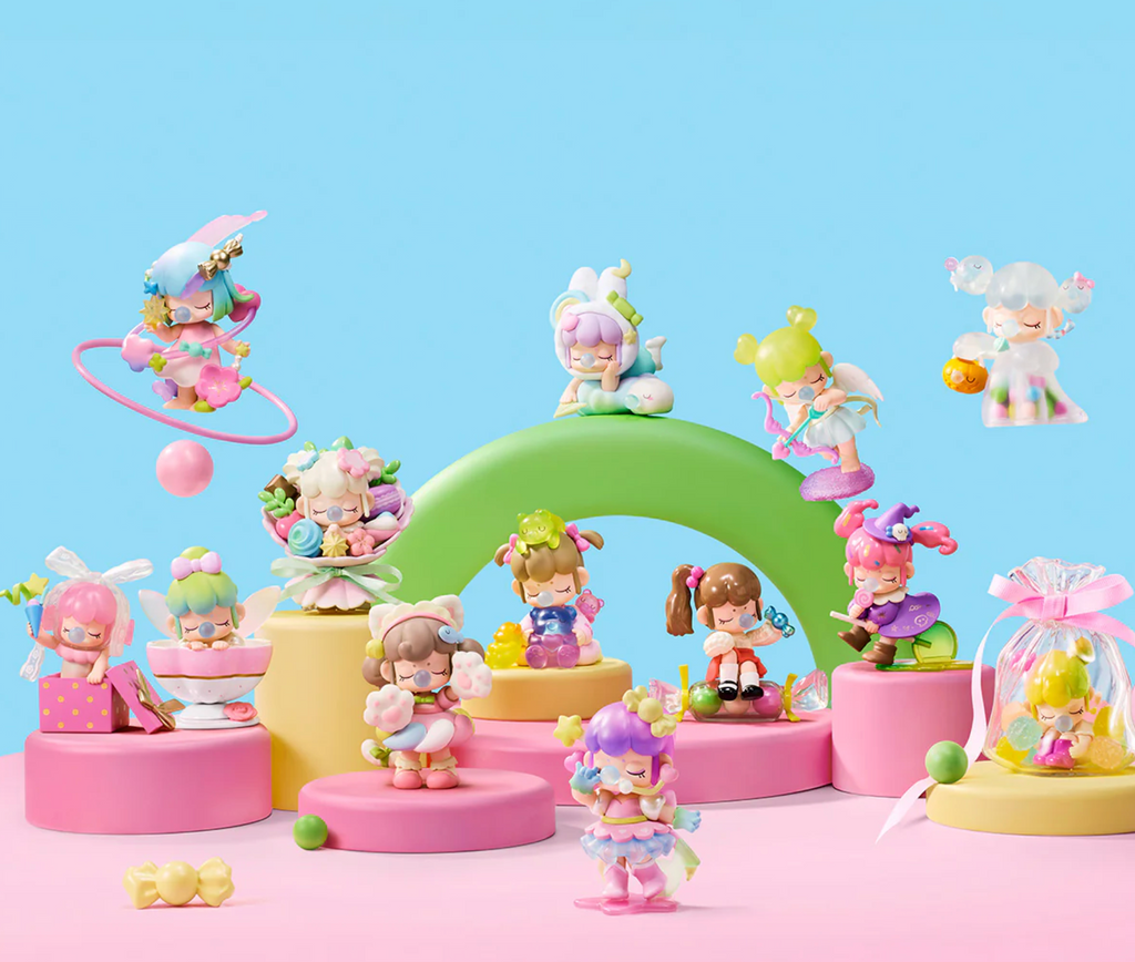 Each of the Nanci Sweet Time collectible figures with accessories pictured o a pink and blue background. 