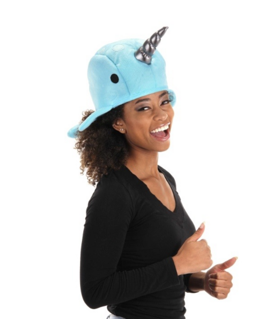 The blue plush Narwhal Hat being worn by a young lady. 