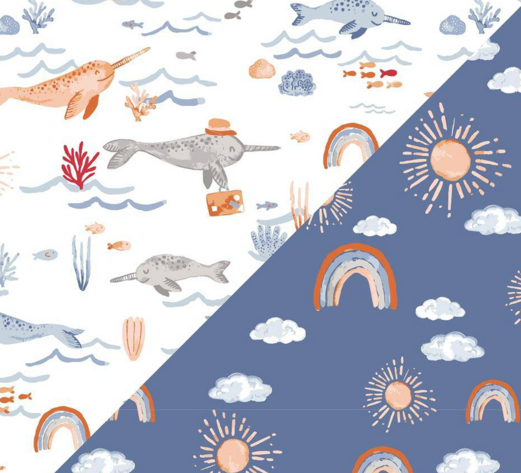 Close up view of the two patterns. Narwhal has a white background with narwhals swimming with fish, some wearing hats and the Hello Sunshine pattern is on a dusty blue background with rainbows, suns and clouds. 