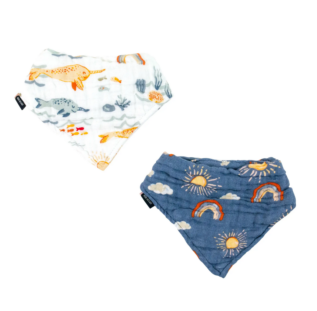 Two muslin bibs one with the Narwhal print and the other with the Hello Sunshine print. 