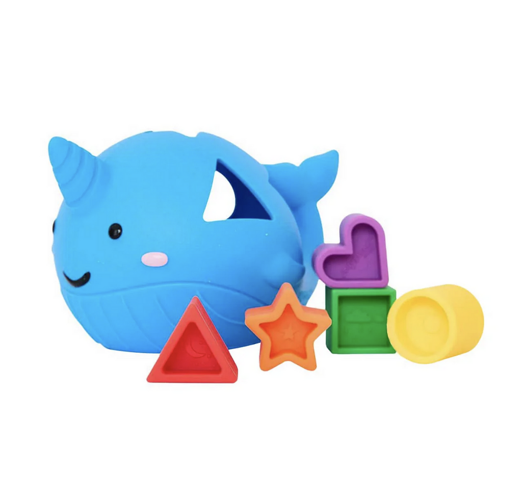 Narwhal shaped shape sorter in blue made from soft silicone with primary colored shapes like a red triangle, orange star, purple heart, green square and yellow circle. 