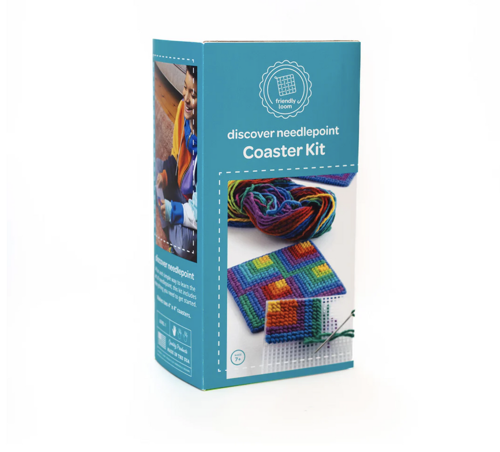 The Needlepoint Coaster Ki packaged  in a blue box featuring a picture of one completed coaster and one in progress. 