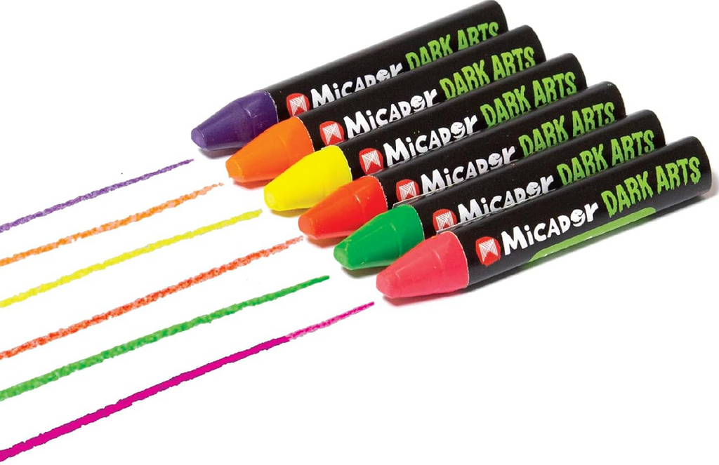 Six neon crayons laid out in a row with a line from each drawn to show the bright and bold color they create. 