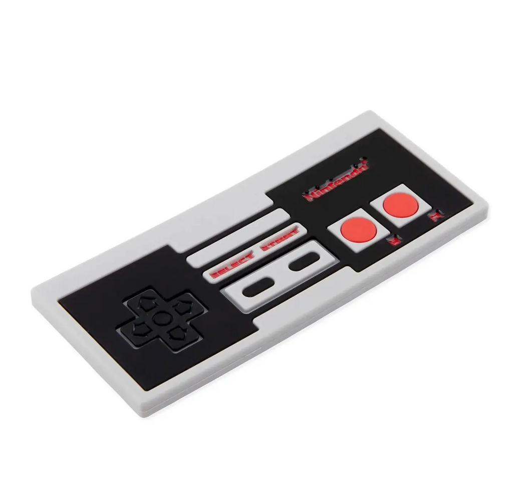 Close up picture of the Nintendo Entertainment System (NES) controller silicone baby teether with black directional buttons and red action buttons. 