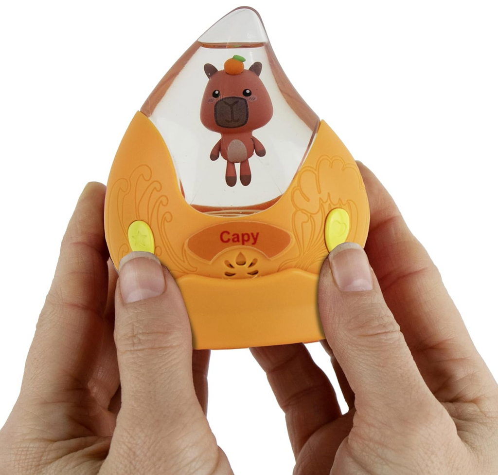 Capy the Capybara Aqua Pet floating in it's raindrop home. There are button on both sides of the raindrop that can make the Aqua Pet sing, dance and talk. 