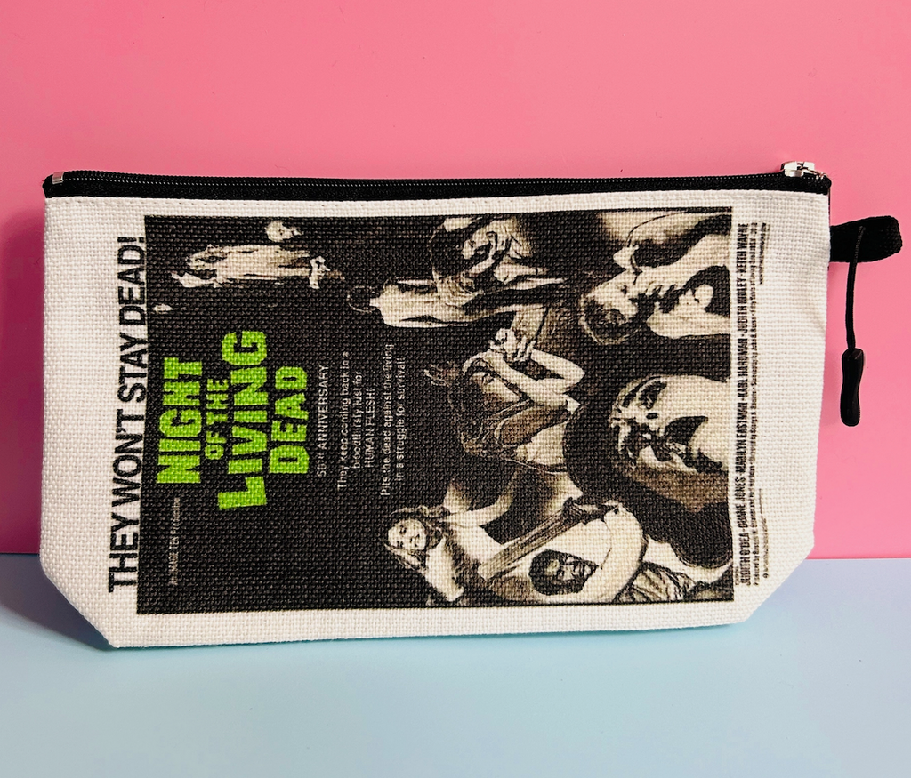 Zippered cosmetic/toiletry bag placed horizontally with graphics from "Night of the Living Dead" 