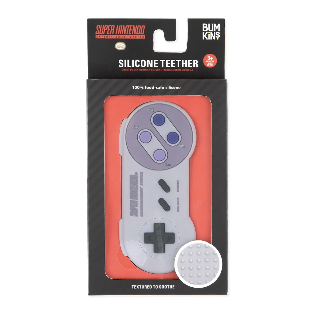 Nintendo SNES silicone teether packaged in a black box with a clear window that shows the teether that looks just like the video game controller with black directional buttons, and blue movement buttons. 