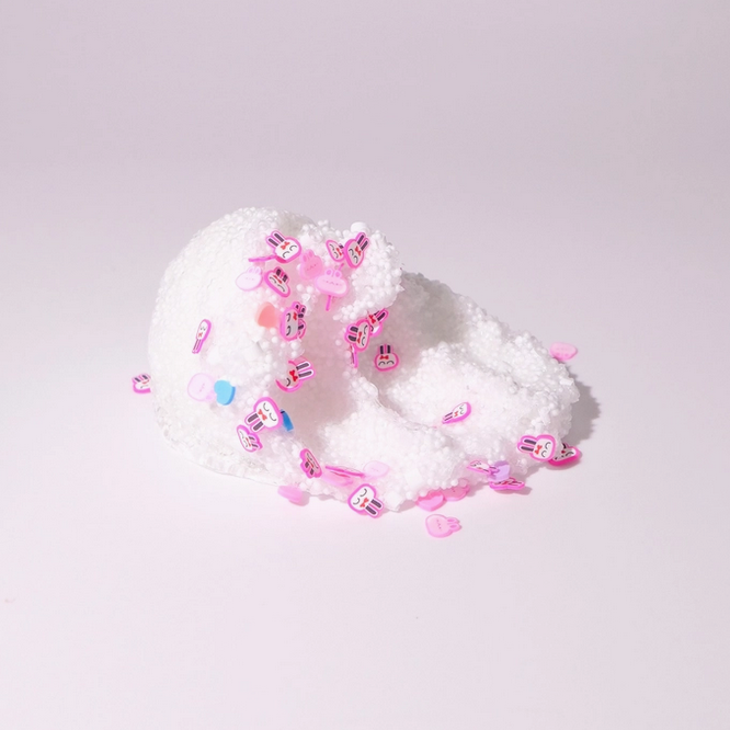 Scoop of white slime with with pink bunny heads and bluand pink heart sprinkles. 