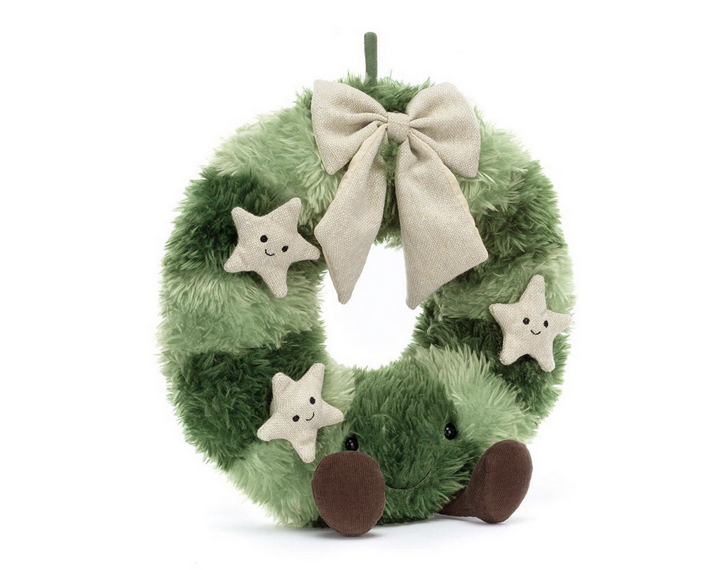 Plush light and dark green striped christmas wreath with beige stars, a beige ribbon, and a smiling face.